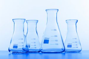 Decorative image with different size of Erlenmeyer flasks for science lab use.