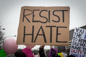 Sign reading Resist Hate at 2017 March.
