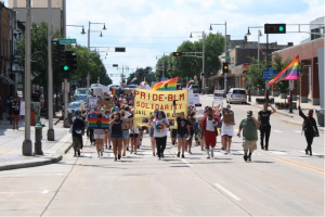 Marchers with banner supporting Pride and BLM.