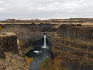 Photo of water fall in a deep, narrow canyon