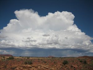 Storm cloud over desert landscape