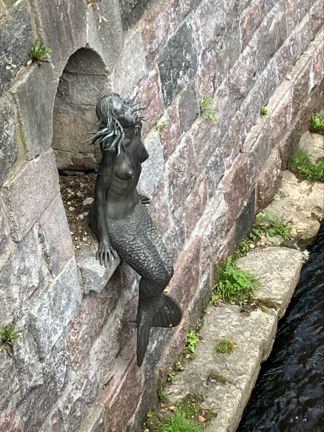 The Mermaid of Užupis - mermaid sculpture next to the river